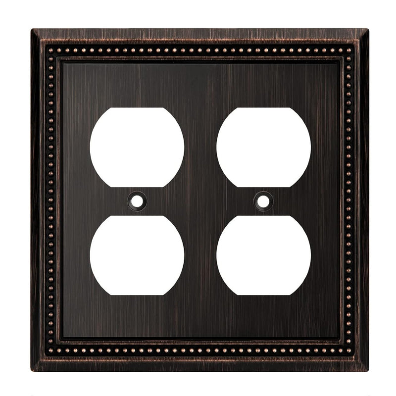 Double electrical outlet cover with bronze frame on a white background