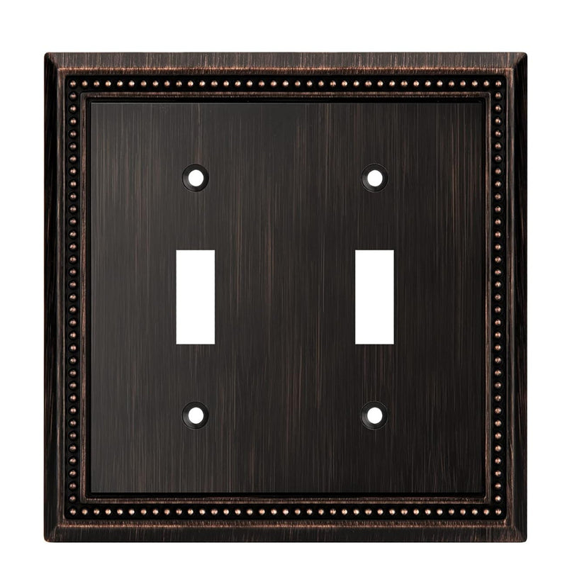 Double toggle switch plate with bronze border on a white background