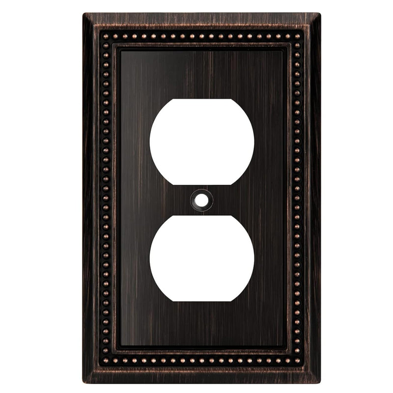 Decorative wall outlet cover with bronze frame and white sockets on a white background