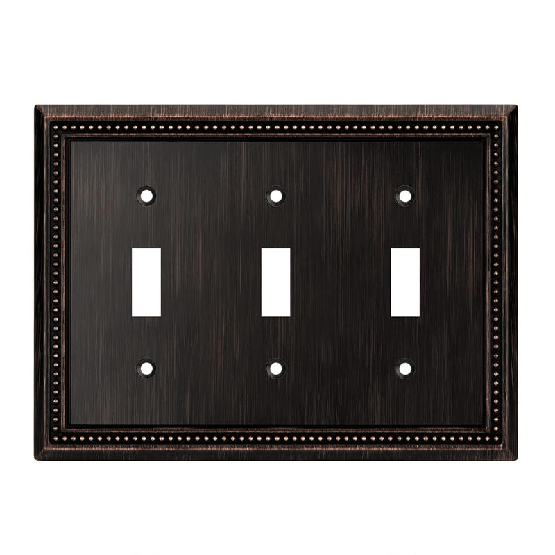Rubbed bronze switch plate with three toggle switches on a white background