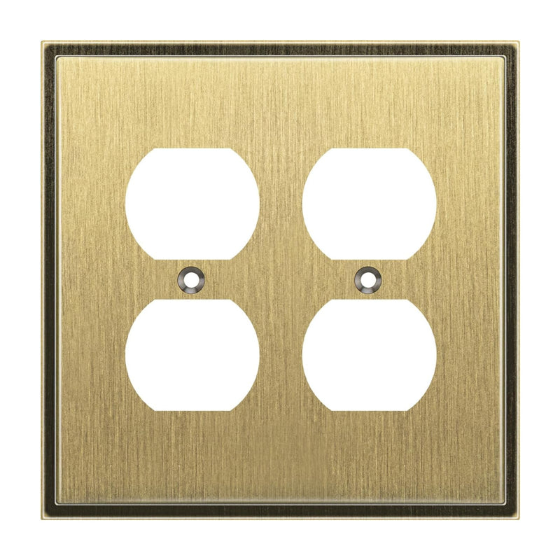 Antique brass electrical outlet cover with four white sockets on a white background