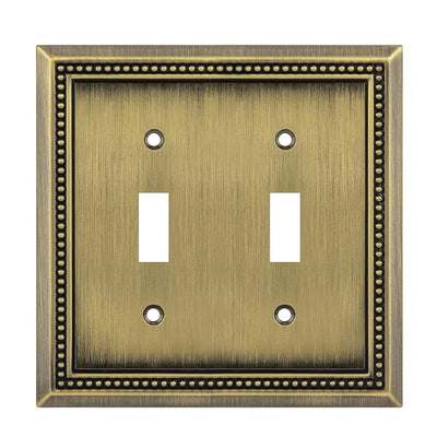Double toggle switch plate with decorative border on a white background