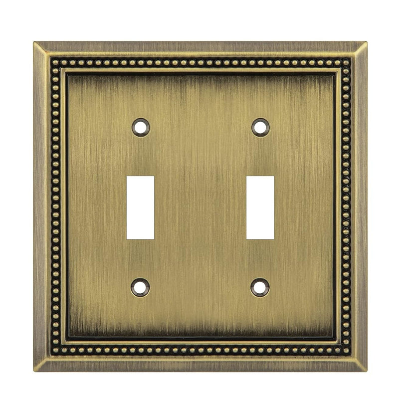 Double toggle switch plate with decorative border on a white background