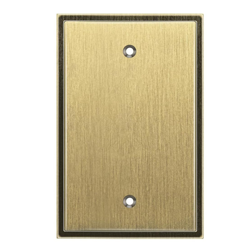Antique brass metal wall plate with two holes on a white background
