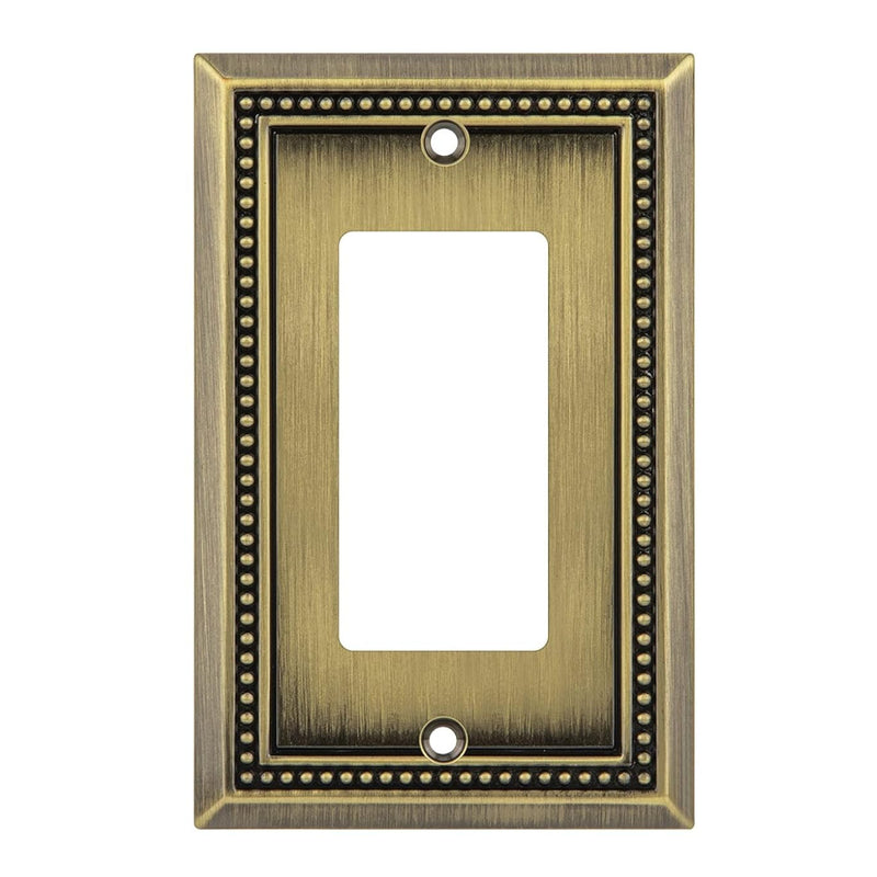Antique brass wall plate with beaded border on a white background