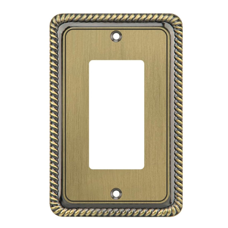 Decorative brass wall plate with intricate border on a white background