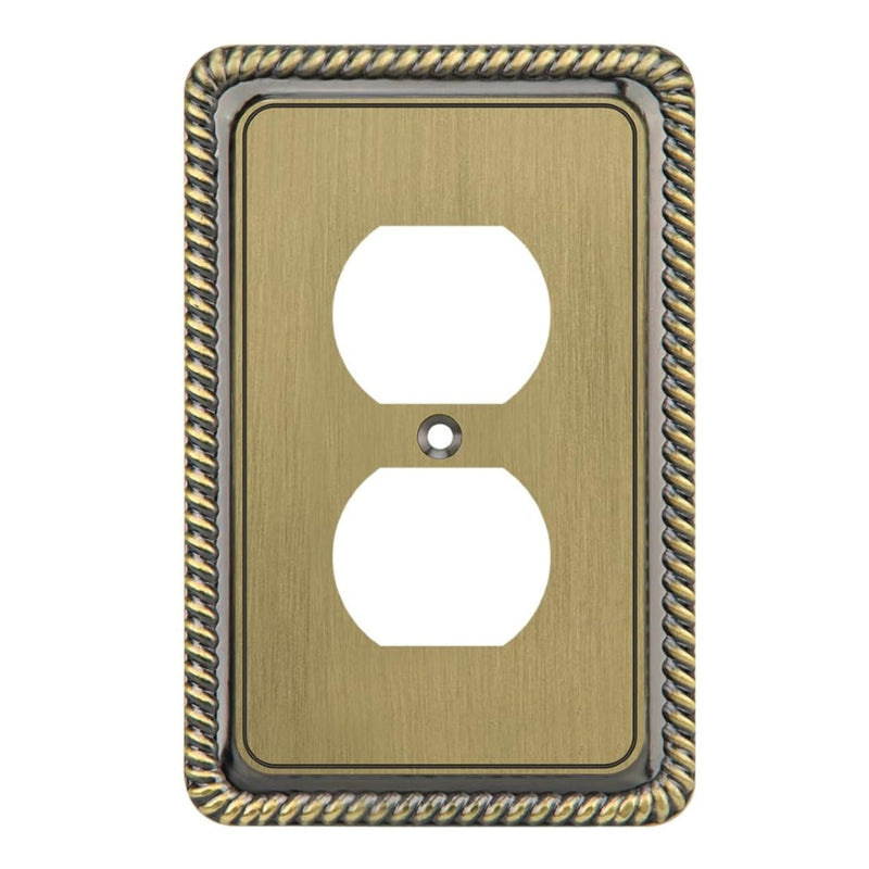 Decorative brass wall outlet cover with intricate border on a white background