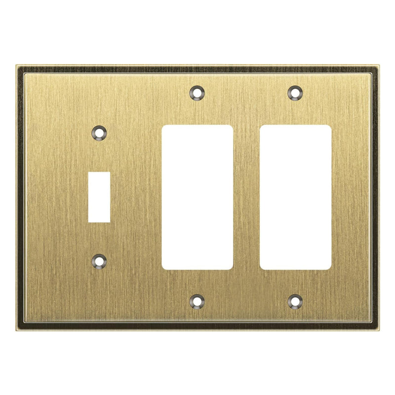 Brass switch plate with three outlets on a white background