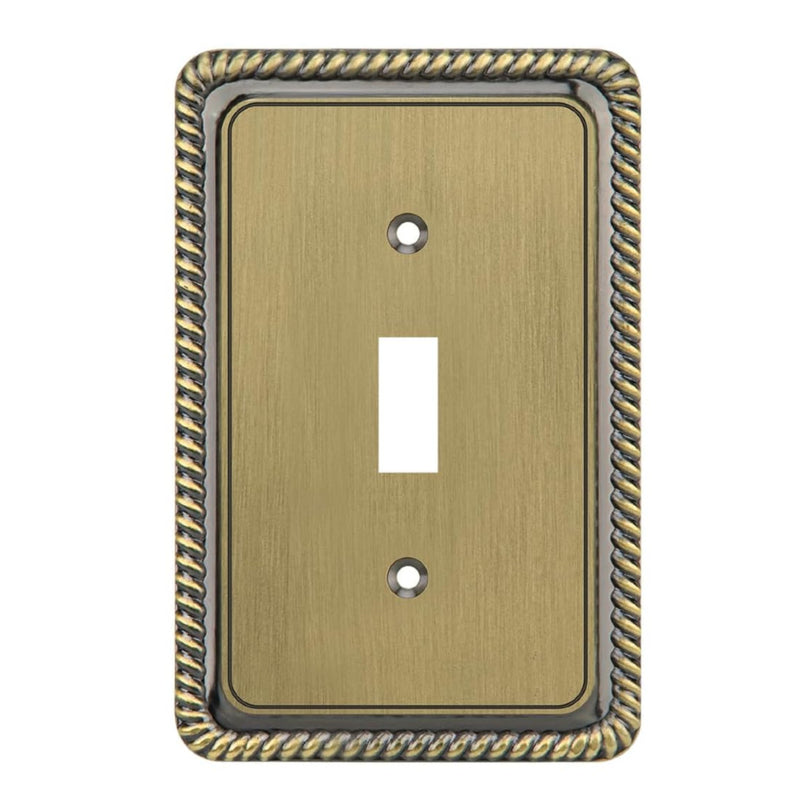 Decorative brass switch plate with decorative border on a white background