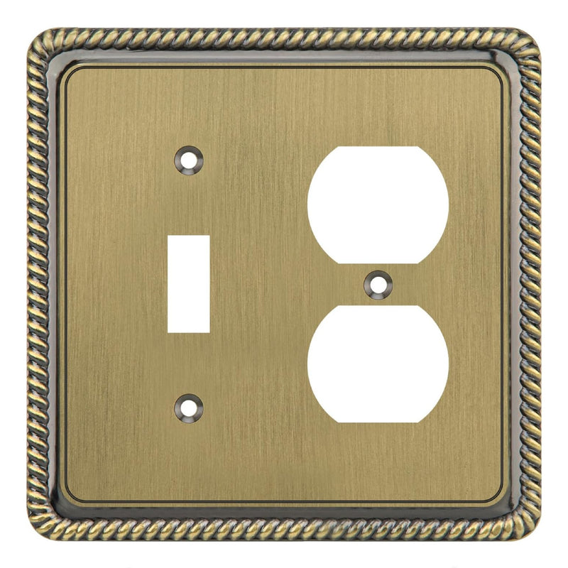 Decorative brass wall plate with a single switch and duplex outlet design.