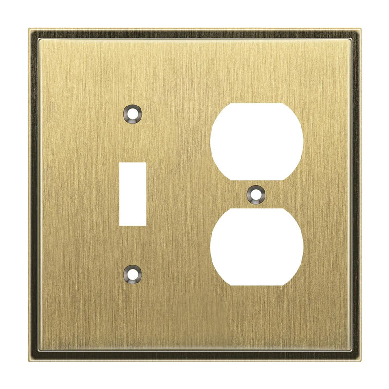 Brass wall plate with two electrical outlets on a white background