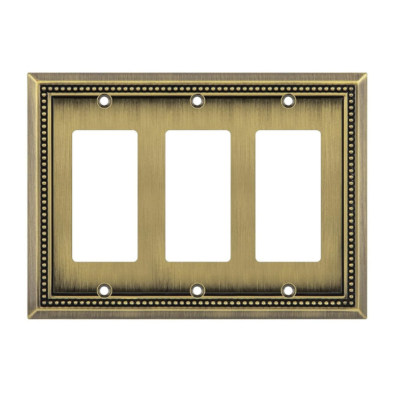 Antique brass three-gang wall plate on a white background