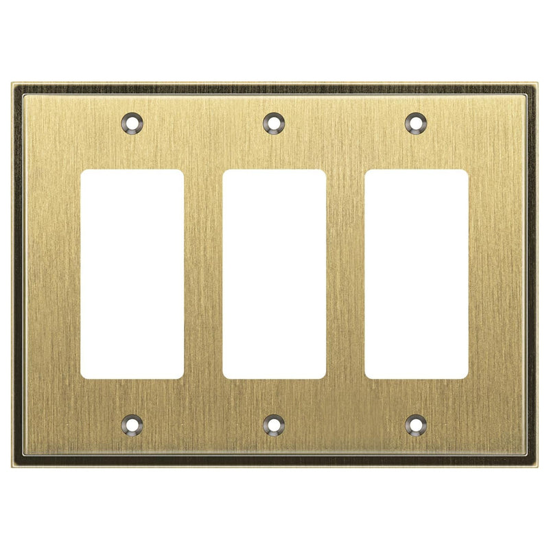 Brass triple gangway switch plate on a white background