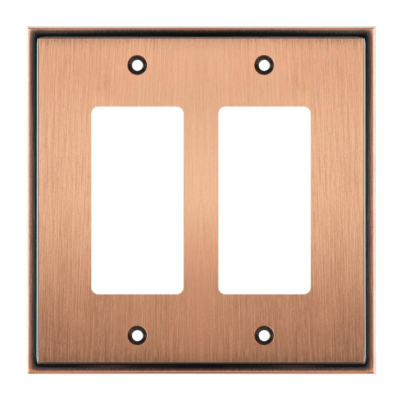 Copper double gang wall plate with two white inserts on a white background