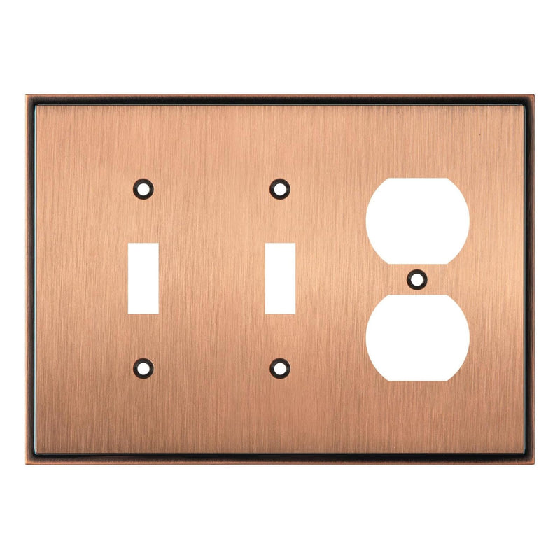 Copper switch plate with two toggle switches and one outlet on a white background