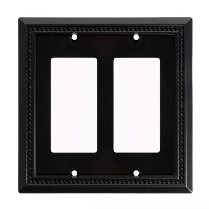 Black double-gang wall plate with decorative border on a white background
