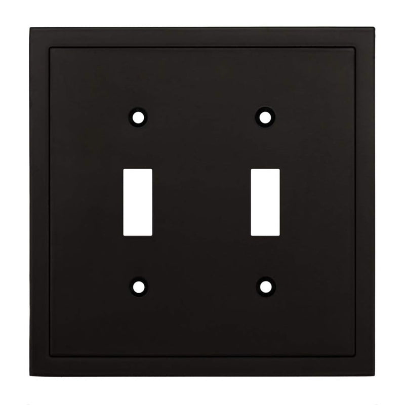 Black double toggle switch plate with white switches on a white background