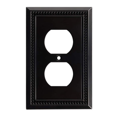 Black decorative wall outlet cover with a white outlet design on a white background