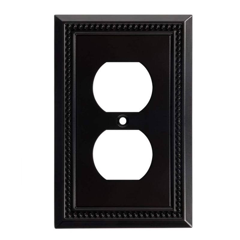 Black decorative wall outlet cover with a white outlet design on a white background