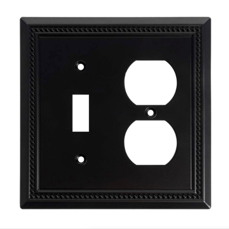 Black wall plate with two electrical outlets on a white background