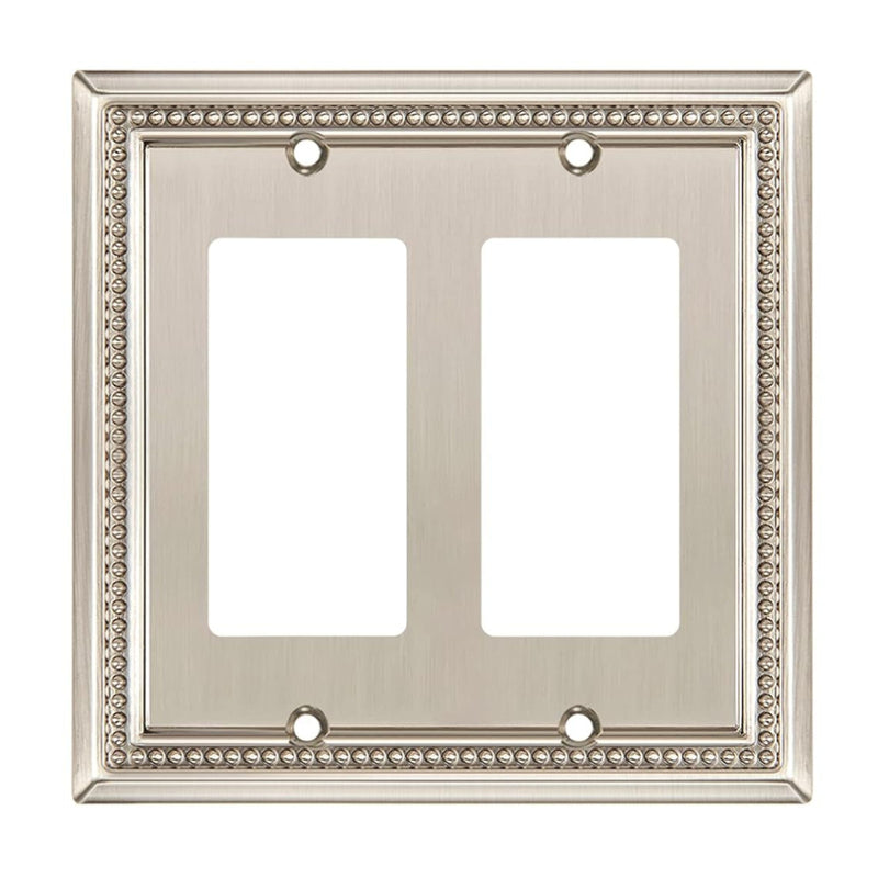Decorative wall plate with two sockets on a white background