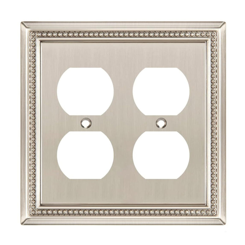 Decorative wall plate with four outlets on a white background