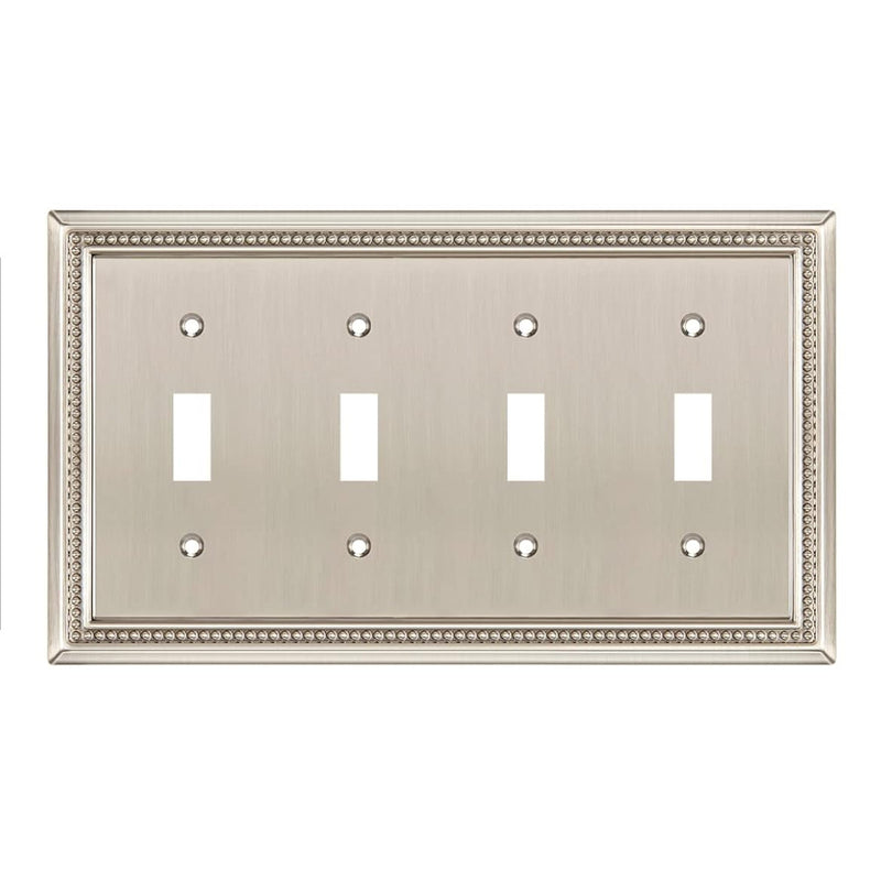 Decorative metallic wall plate with four toggle switches on a white background