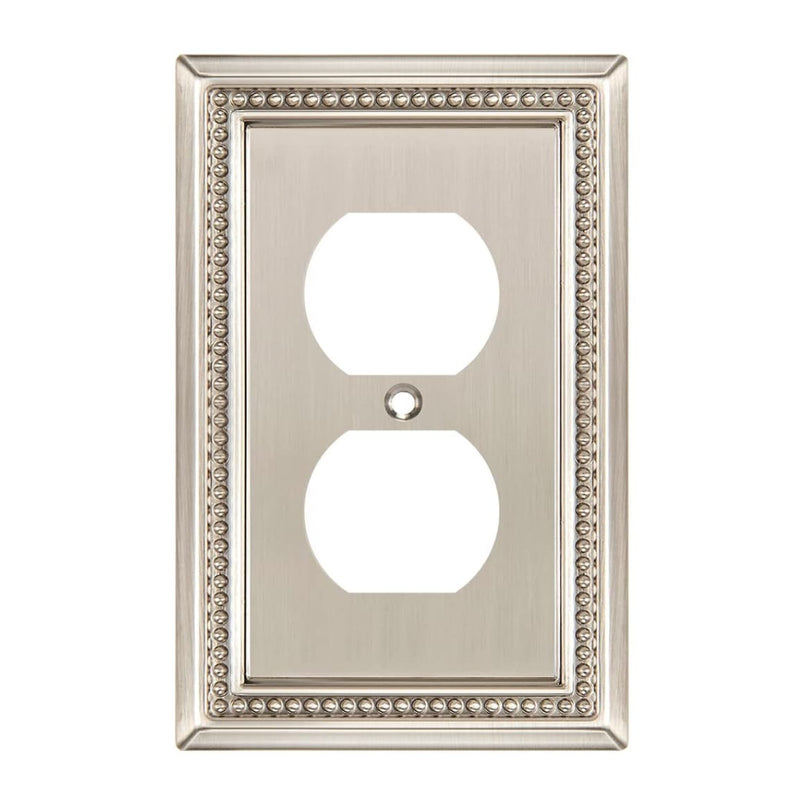 Decorative wall outlet cover with ornate border on a white background