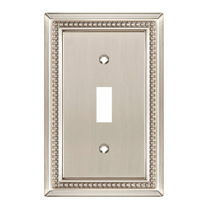 Decorative light switch cover with ornate border on a white background