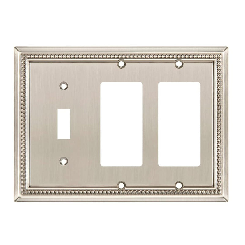 Decorative metal wall plate with three outlets on a white background