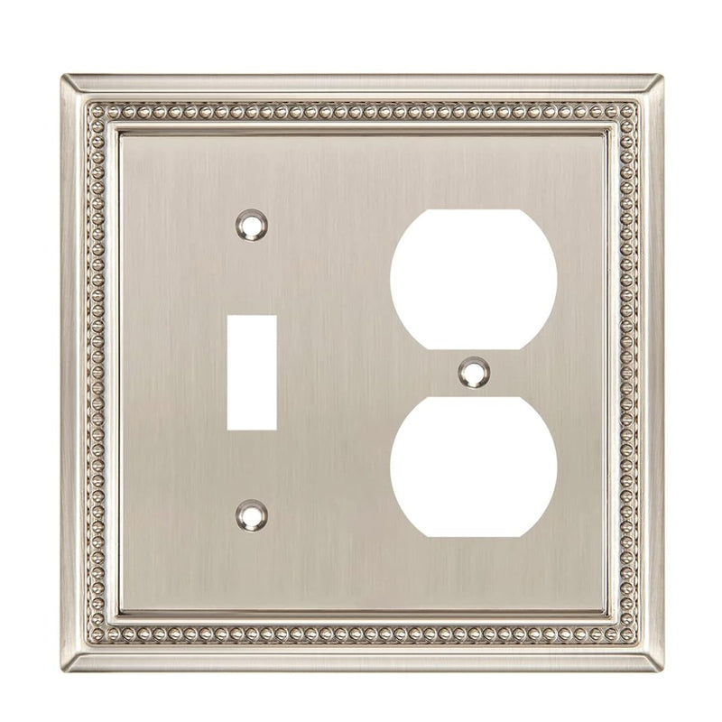 Decorative wall plate with a switch and outlet cutout on a white background