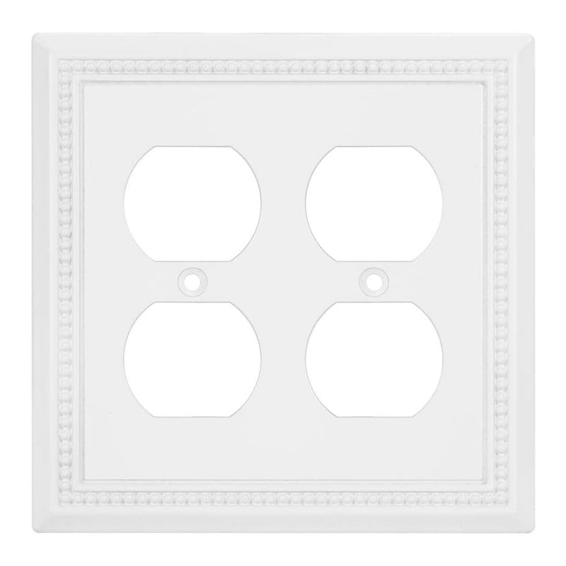 White wall plate with four electrical outlets on a white background