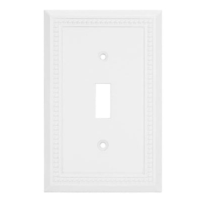White wall switch plate with decorative border on a white background