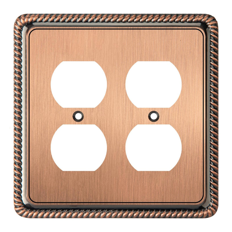 Antique copper double electrical outlet cover with decorative border on a white background