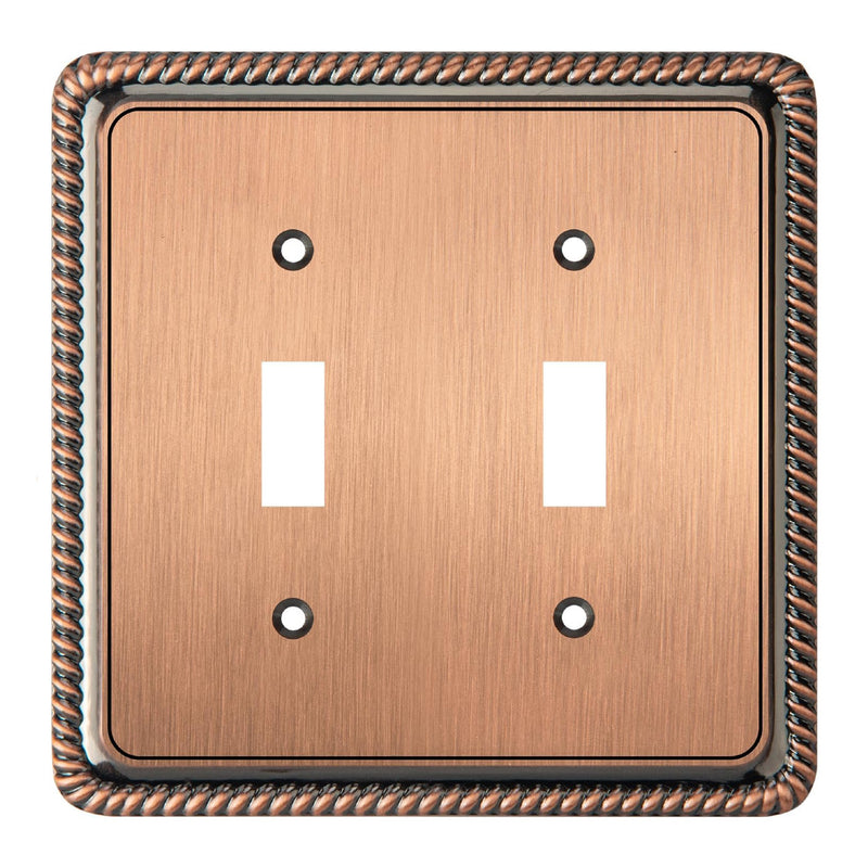 Copper double toggle switch plate with decorative border on a white background
