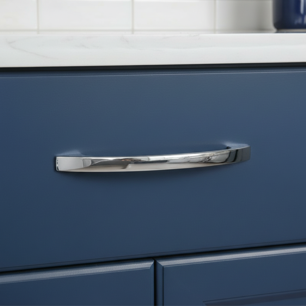 Blue cabinet with a chrome handle in a kitchen setting