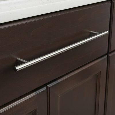 Close-up of a dark wooden cabinet with a shiny metal handle.