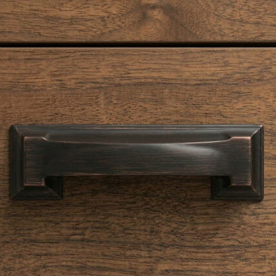 Wooden drawer with metal handles on a wooden surface