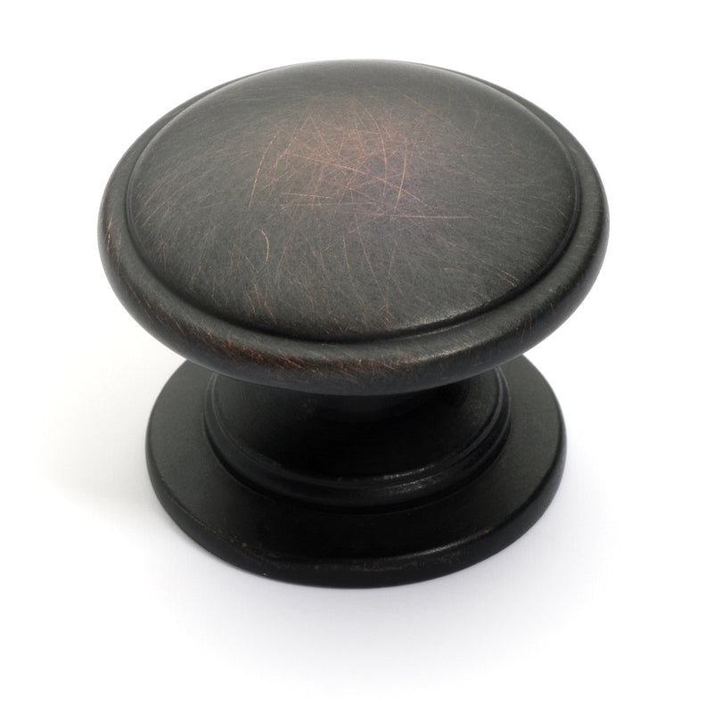 Classic drawer knob in oil rubbed bronze finish with slightly raised center and one and a quarter inch diameter