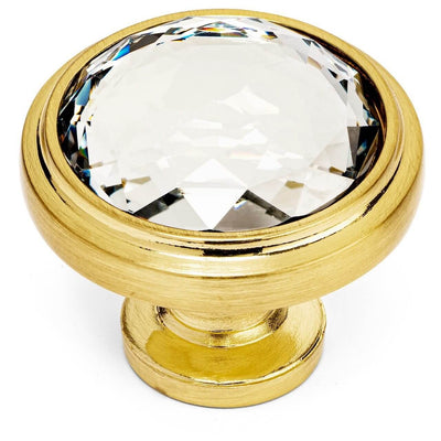 Drawer knob in brushed brass finish with crystal surrounded by the metal