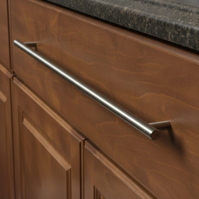 Satin nickel euro style bar pull on a dark wood drawer 