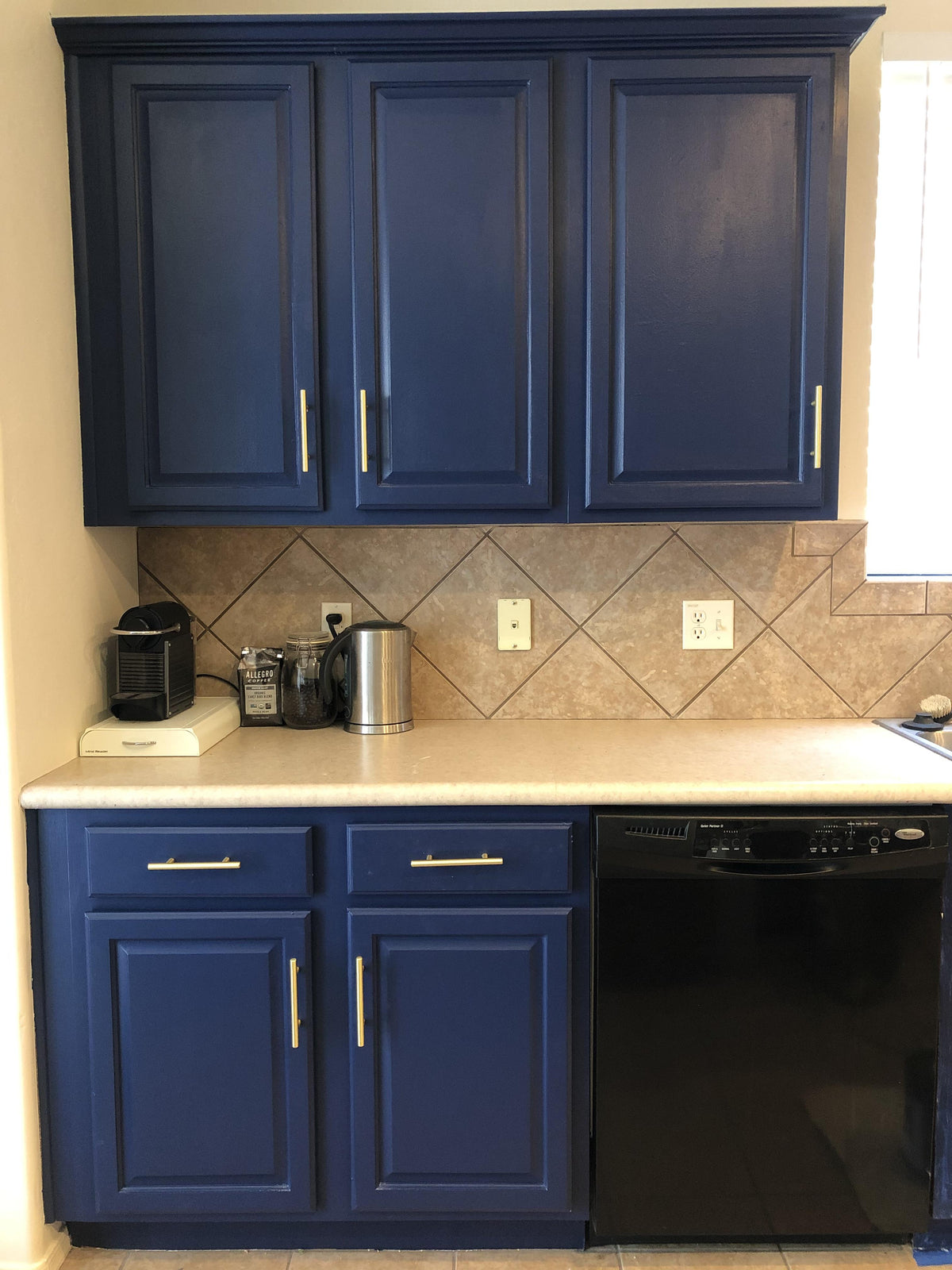 Cosmas 305-96BB Brushed Brass Euro Style Bar Pull on navy blue cabinets 