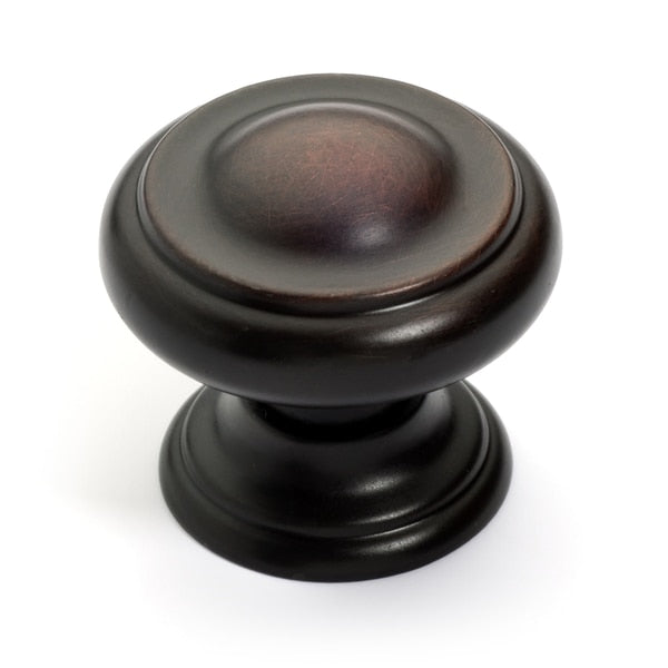 Round drawer knob with raised center in oil rubbed bronze finish with one and three sixteenths inch diameter