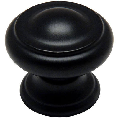 Round cabinet knob in flat black finish with slightly raised ring and one and three sixteenths diameter