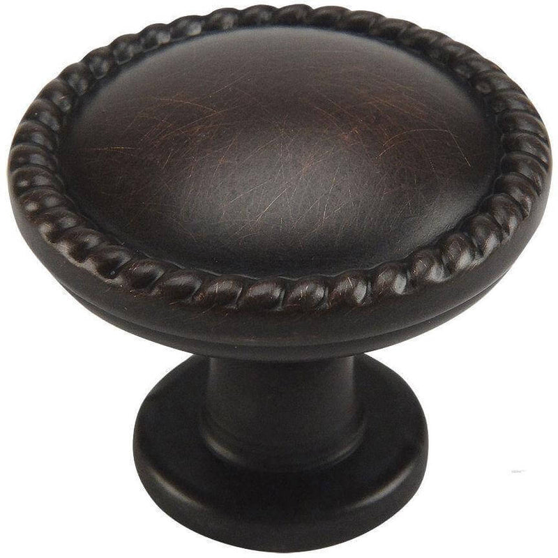 Oil rubbed bronze drawer knob with rope design at the edges and one and a quarter inch diameter