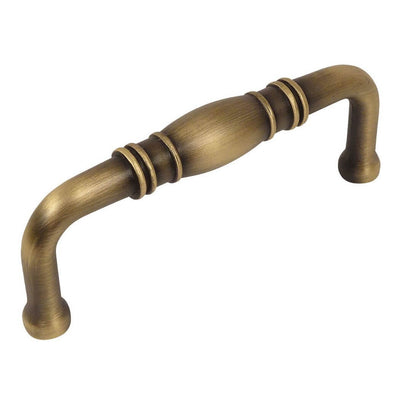 Cabinet pull with brushed antique brass finish with a bulge at the centre and three inch hole spacing