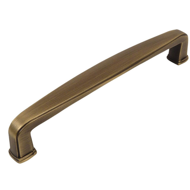 Subtle wide cabinet drawer pull in brushed antique brass finish with six and five sixteenths inch hole spacing