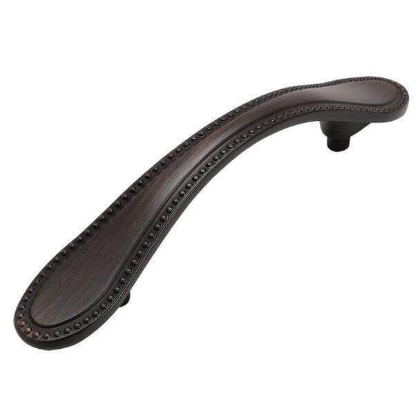 Oil rubbed bronze cabinet pull with small dots on the edge and three inch hole spacing