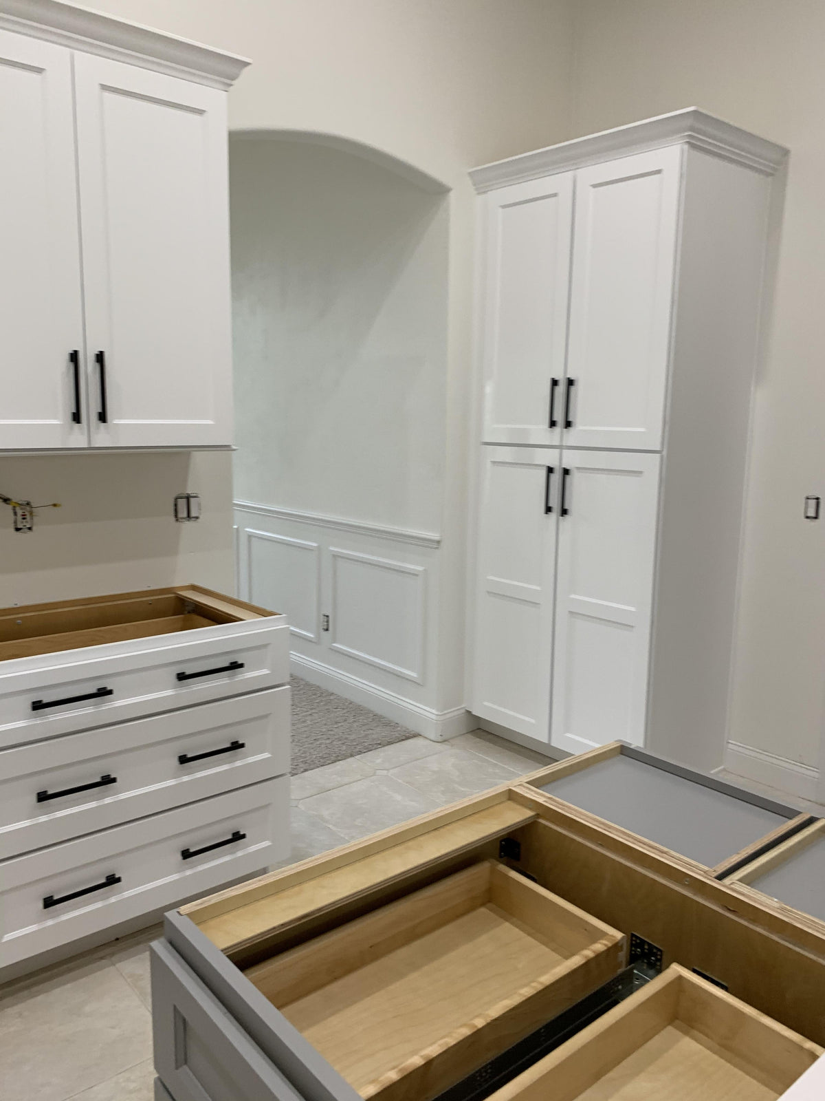 Solid metal black cabinet pulls on white and gray cabinets