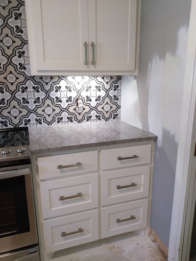 702-3.5SN Cosmas pull on white shaker kitchen cabinets with floral backsplash. 